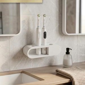 Può includere: Un portaspazzolini da parete bianco con due spazzolini elettrici. Il supporto ha spazio per due spazzolini e due oggetti aggiuntivi. Le parole "BEST SELLER" sono visualizzate sopra gli spazzolini.