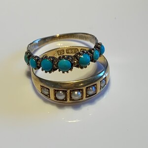 May include: Two gold rings, one with turquoise stones and the other with pearls. The turquoise ring has the inscription "15 625" on the band.