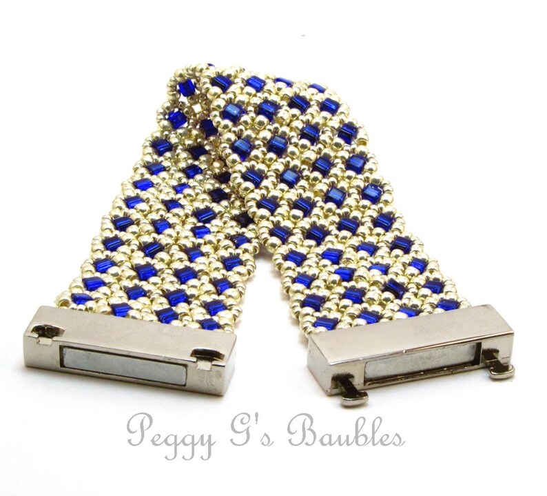 May include: A gold and blue beaded bracelet with magnetic clasps. The bracelet is made with small, square beads in a checkered pattern.