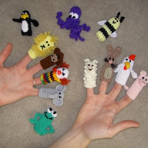 May include: A set of ten finger puppets, including a penguin, lion, bear, clown, elephant, frog, bee, octopus, rabbit, and a chicken. The puppets are made of crocheted yarn in various colors.