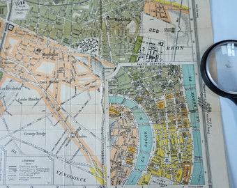 May include: A vintage map of Lyon, France, showing the city's streets, rivers, and landmarks. The map is printed in black, white, and yellow, and includes a legend with details about the city's infrastructure.