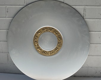 May include: A silver serving tray with a gold rim featuring a design of zodiac symbols.