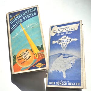 May include: Two vintage road maps from the 1930s or 1940s. The map on the left is for Northeastern United States and features a yellow tower with the text "World's Fair Edition". The map on the right is for Eastern United States and features a blue and white map of the eastern United States with the text "Gas Sunoco Oils" and "Compliments of Your Sunoco Dealer".