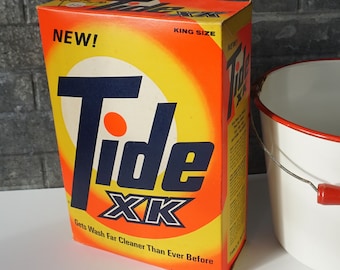 May include: A vintage box of Tide XK laundry detergent. The box is orange and yellow with a blue and white Tide logo. The box says "New!" and "King Size" and "Gets Wash Far Cleaner Than Ever Before". The box is 147g.