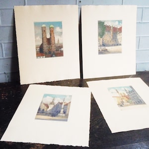 May include: Four framed prints of different architectural scenes in black and white. The prints are matted and have a white background.