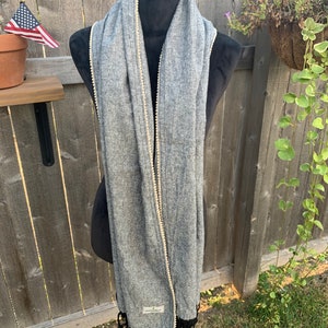 Scarf/Shawl in black designer linen, with a beige trim and a shredded end. Black/ gray shawl .