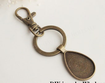 10 set fotonyckelringar DIY-kit droppformade 20 x 30 mm, nyckelringstillbehör hängen, nyckelringar tom ram, basfattning, nyckelringskedjor