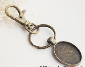 10 set fotonyckelringar DIY-kit 18 x 25 mm, nyckelringstillbehör hängen, nyckelringar tom ram, basinfattning, nyckelringskedjor