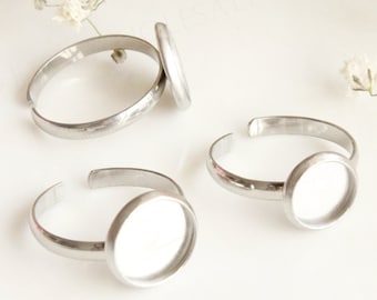May include: Three silver adjustable rings with round, clear glass cabochons. DIY jewelry wholesale jewelry findings supplies.