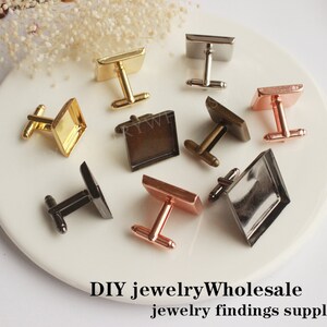 May include: Assortment of cufflinks with square glass or metal insets. The cufflinks are in various finishes, including gold, silver, bronze, and rose gold.