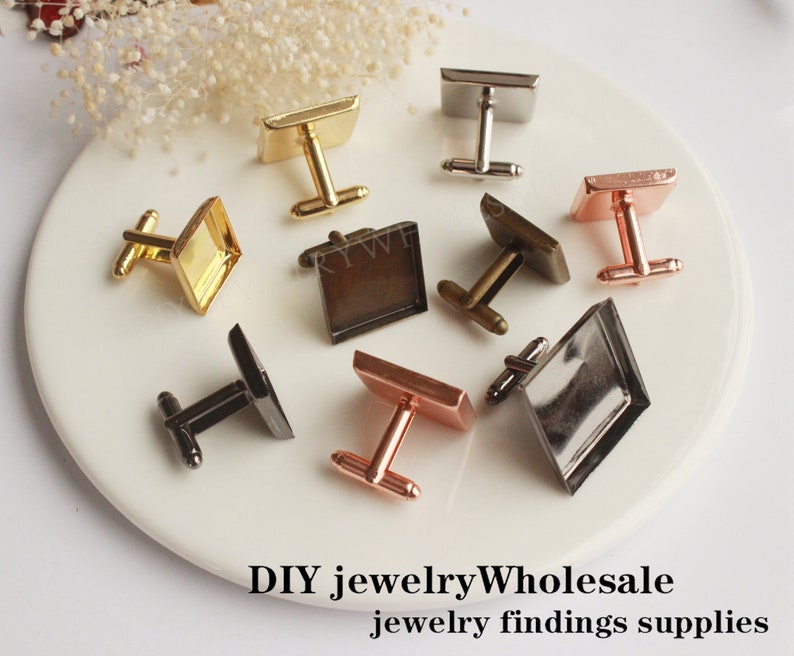 May include: Assortment of cufflinks with square glass or metal insets. The cufflinks are in various finishes, including gold, silver, bronze, and rose gold.