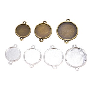 May include: Assortment of round metal bezel trays with three loops for hanging. The trays are available in two finishes: antique brass and silver.