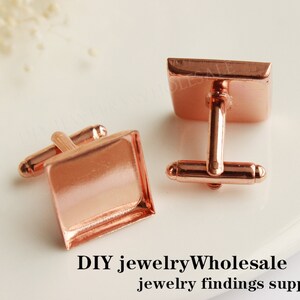 May include: Two rose gold cufflinks with square settings. The cufflinks are made of metal and have a polished finish.