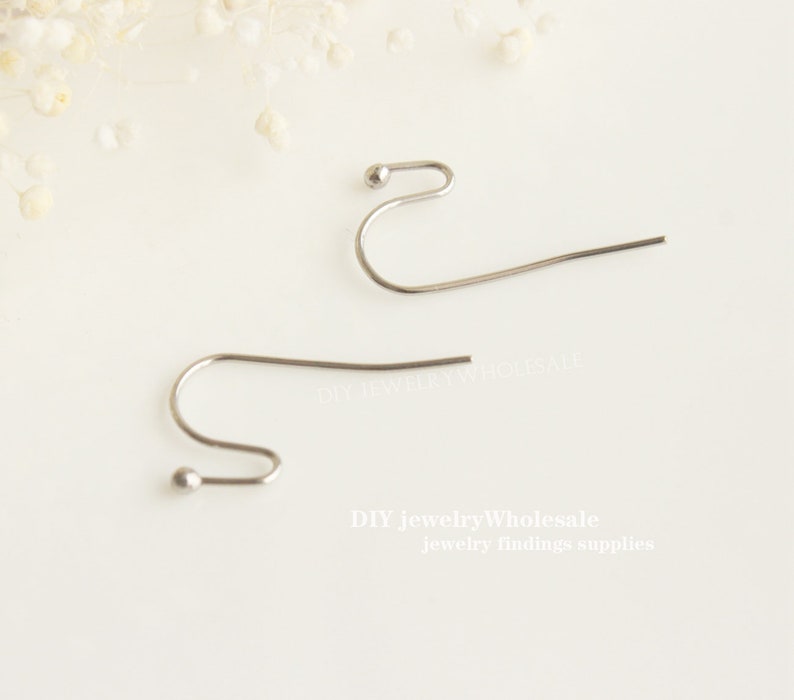May include: Two silver earring hooks with a small ball at the top of each hook. DIY Jewelry Wholesale jewellery findings supplies.