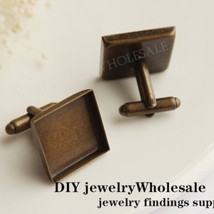 May include: Two antique gold cufflinks with square glass inserts. The cufflinks are made of metal and have a simple design. DIY jewelryWholesale jewelry findings supplies.