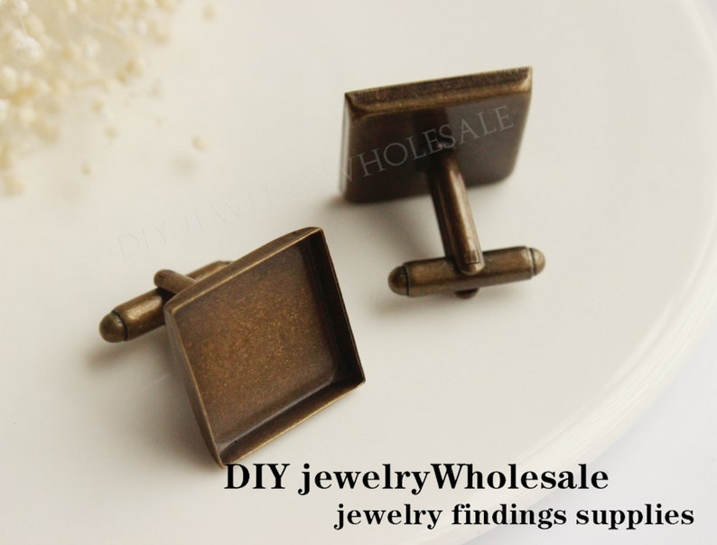 May include: Two antique gold cufflinks with square glass inserts. The cufflinks are made of metal and have a simple design. DIY jewelryWholesale jewelry findings supplies.