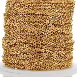 May include: A spool of gold-colored chain, perfect for jewelry making. The chain is made of small, linked oval shapes.