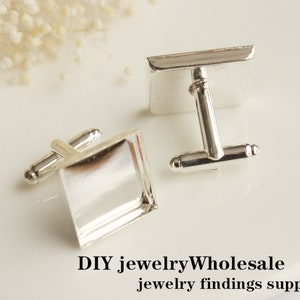May include: Two silver cufflinks with square, clear glass inserts. The cufflinks are on a white surface. DIY jewelry Wholesale jewelry findings supplies.
