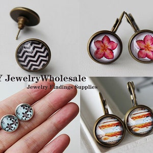 May include: Assortment of DIY jewelry findings, including earring hooks and glass cabochons with various designs. The designs include a black and white chevron pattern, a pink flower, a blue floral pattern, and a colorful planet-like image.
