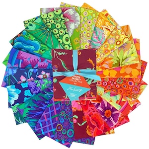 May include: A collection of colorful fabric squares arranged in a circular pattern. The fabrics feature vibrant floral and abstract designs in shades of green, blue, purple, orange, and red. A bundle of maroon fabric is tied with a teal ribbon and a tag that reads "Kaffe Fassett Collective for Free Spirit."