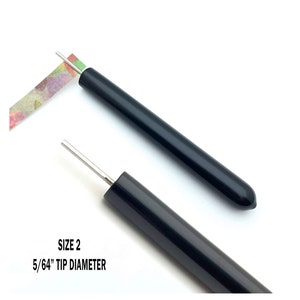 Paper Bead Roller Quilling Tool with 5/64 inch diameter Slotted Tip and black vinyl covered handle. Paper roller has strip of paper in tip.