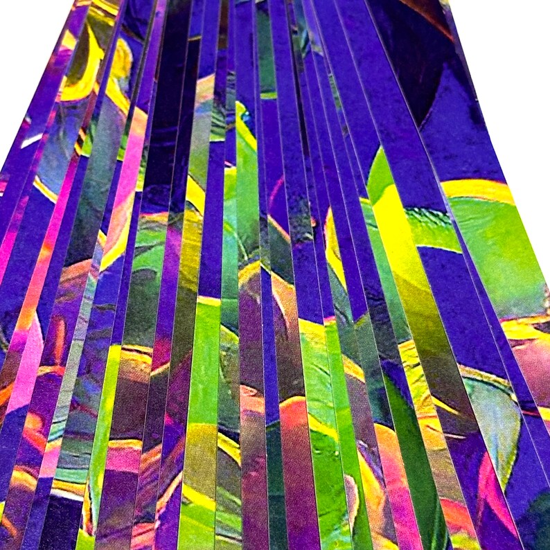 May include: A close-up of a colorful abstract design with vertical stripes of purple, green, yellow, and pink.