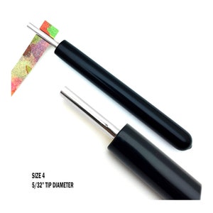 Paper Bead Roller Quilling Tool with 5/32 inch diameter Slotted Tip and black vinyl covered handle. Paper roller has strip of paper in tip.