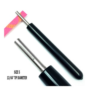 Paper Bead Roller Quilling Tool with 13/64 inch diameter Slotted Tip and black vinyl covered handle. Paper roller has strip of paper in tip.