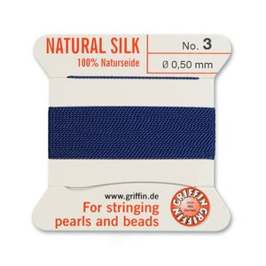 May include: A spool of dark blue natural silk thread for stringing pearls and beads. The spool is labelled "NATURAL SILK 100% Naturseide No. 3 &Oslash; 0,50 mm" and "For stringing pearls and beads".