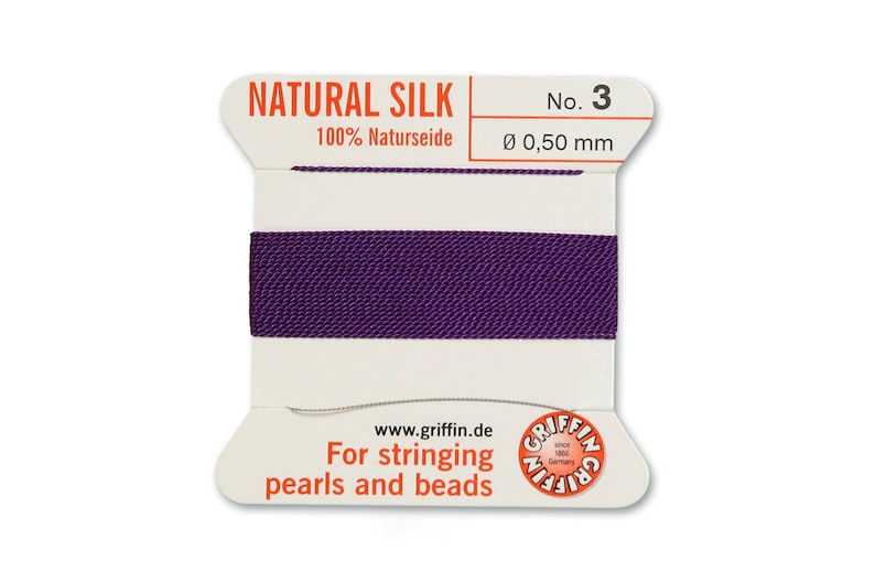 May include: A spool of purple natural silk thread for stringing pearls and beads. The spool is labelled "NATURAL SILK 100% Naturseide No. 3 &Oslash; 0,50 mm" and "For stringing pearls and beads www.griffin.de".