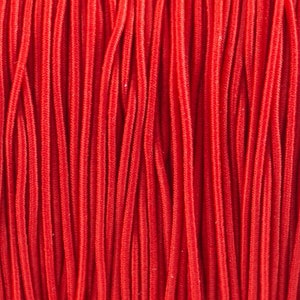 May include: A close-up of a bundle of red cords, all lined up in a parallel pattern.