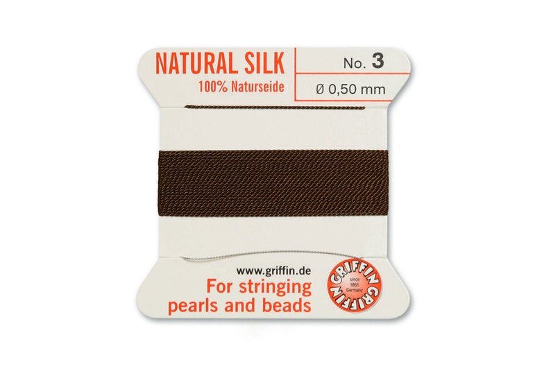 May include: A spool of brown natural silk thread for stringing pearls and beads. The spool is labelled "NATURAL SILK 100% Naturseide No. 3 &Oslash; 0,50 mm" and "For stringing pearls and beads".