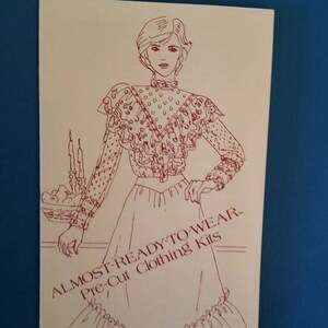 May include: A line drawing of a woman wearing a ruffled blouse and skirt. The text "ALMOST-READY-TO-WEAR.. Pre-Cut Clothing Kits by The Patchmakers." is printed on the page.