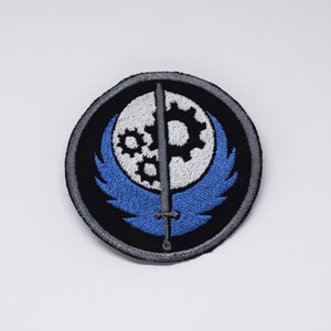 Machine Brotherhood - Écusson thermocollant - Broderie métallisée brillante.