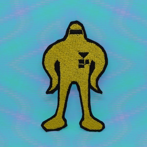 May include: Yellow embroidered patch of a stick figure wearing a black mask and a black symbol on its chest. The figure has large arms and legs.