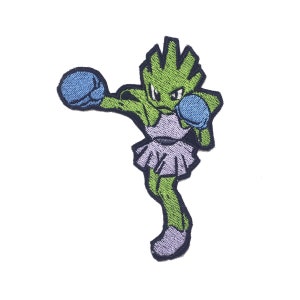 May include: Green and blue embroidered iron-on patch of a cartoon character wearing boxing gloves and a purple skirt.