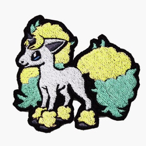 Pode incluir: Etiqueta bordada de um personagem Pokemon branco e amarelo com um olho azul. O personagem tem uma juba e uma cauda amarelas.