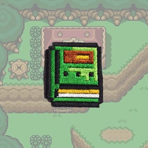 Zelda Link to the past - Book of Mudora - opstrijkbare patch - glanzend metallic geborduurd.   Zelda-patch.