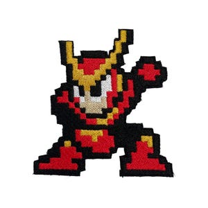 May include: Embroidered patch featuring a pixelated character in a dynamic pose. The design showcases a figure with a red and black color scheme, accented with yellow details. The character has a white face and is likely from a video game.