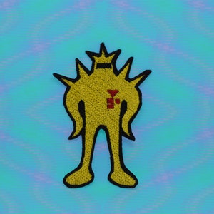 May include: Yellow embroidered patch of a cartoon figure with a crown, spikes, and a red symbol on its chest.