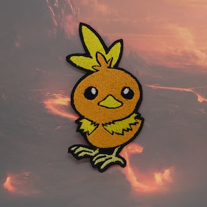 May include: A yellow and orange embroidered patch of a cartoon bird with a yellow crest. The bird has black eyes and a black beak. The patch is on a brown and orange background.