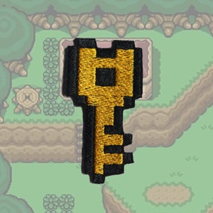 Zelda Link to the Past - Sleutel - Opstrijkbare patch - Glanzend metallic geborduurd.   Zelda-patch.