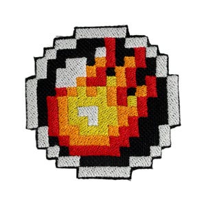 May include: A pixelated embroidered patch with a red, orange, and yellow flame design on a black background. The patch is surrounded by a white border.