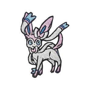 May include: An embroidered patch featuring a white and pink Pokemon character with blue accents. The character has a long, flowing tail and large, blue eyes.
