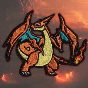 May include: Embroidered patch of a fiery orange and yellow dragon with blue wings. The dragon is standing on its hind legs with its wings spread out. The dragon has a flame tail.