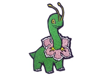 May include: Green embroidered patch of a cartoon dinosaur wearing a pink flower. The dinosaur has a long neck and yellow antennae.