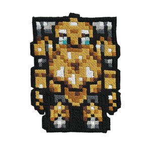 May include: Embroidered patch featuring a pixelated robot design in shades of gold, brown, gray, and black. The robot has a blocky appearance with detailed stitching, and is set against a black background. This patch is suitable for jackets, bags, or other fabric items.