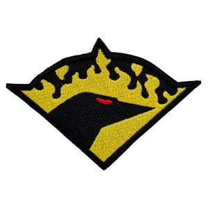 May include: A black and yellow embroidered patch with a stylized raven silhouette and a red eye. The raven is surrounded by a yellow flame design.