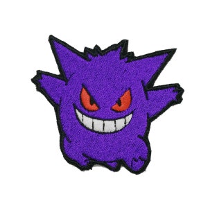 May include: Purple and black embroidered patch of a cartoon ghost with red eyes and a wide grin.