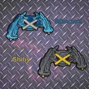 May include: Two embroidered patches of a Pokemon character, one blue and one gray, with the text "Standard" and "Shiny" above each.